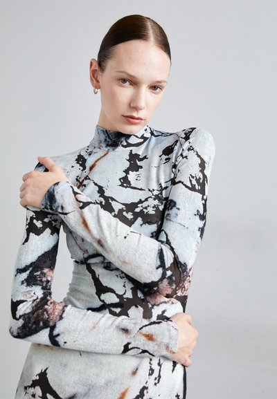 Long-sleeve fitted dress in light blue and black marble pattern, made from soft textured fabric with a mock neck. Accentuates the figure.