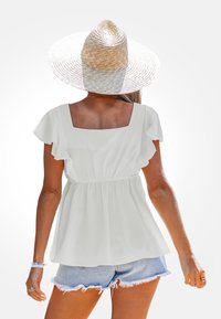 Top blanco, ligero y de manga corta con escote cuadrado y mangas con volantes, combinado con pantalones cortos de mezclilla claros.