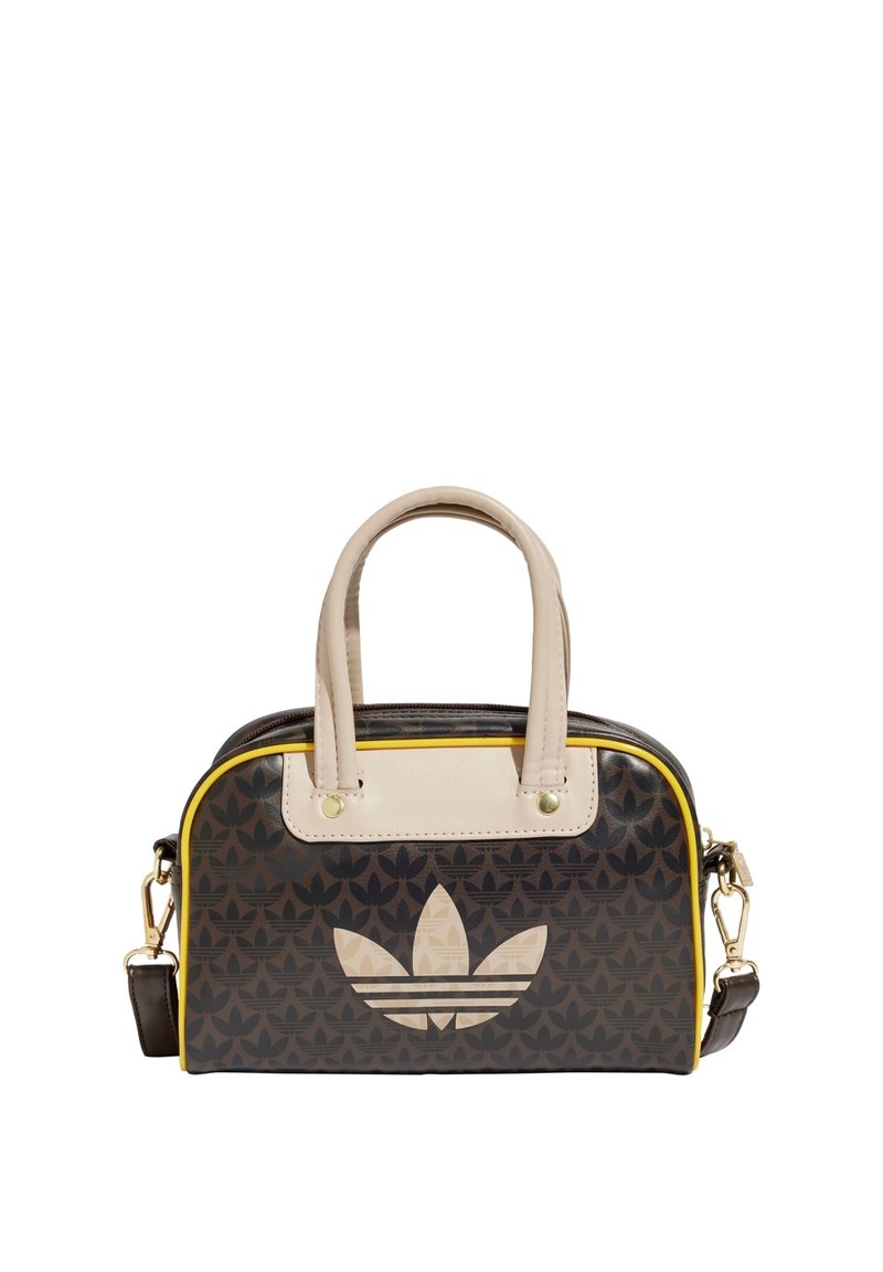 Borsa a mano con motivo nero e giallo, manici robusti, forma strutturata e grande logo chiaro. Presenta dettagli in tonalità oro e una cerniera.