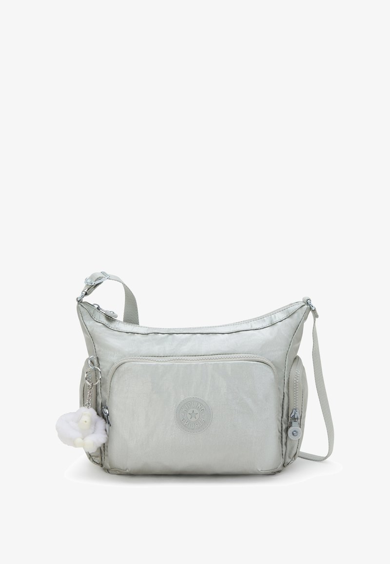 Metallic silver shoulder bag with a smooth texture, featuring a front pocket, logo patch, and a detachable charm of a white fluffy animal.