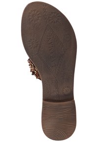 Brown shoe sole with textured floral patterns and a diamond motif, featuring a size imprint of 37 and a smooth, curved edge for comfort.