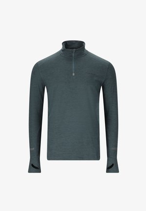 Pull-over à col zippé à manches longues en bleu sarcelle, avec un tissu texturé, présentant des orifices pour les pouces au niveau des poignets et un logo subtil sur la poitrine.