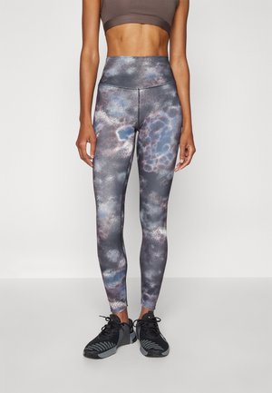 High-waisted leggings in a colorful, cloudy pattern of dark gray, blue, and lavender, made from a smooth, stretchy material.
