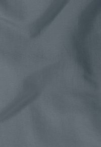 Textured fabric in a muted blue shade with a subtle, fine woven pattern. The surface appears smooth, with slight variations in light and shadow.