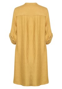 Sinise kollase tooniga tunik-kleit, millel on tekstureeritud kortsus kangas, lõdvestunud lõige, ülesse keeratavad varrukad ja tagumine õmbluse detail.