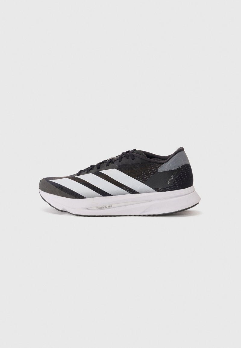 Black athletic shoe with white stripes, mesh upper, cushioned sole, and textured accents. Lightweight design for improved performance.