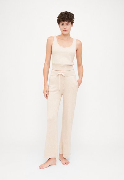 Beige knit tank top and matching wide-leg pants with a drawstring waist, featuring a soft texture and a relaxed fit.