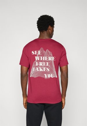 Red short-sleeve T-shirt featuring white text and a mountain graphic on the back. Crew neck and relaxed fit. Soft, lightweight fabric.