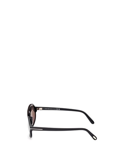 Black sunglasses with an angular frame, glossy finish, and gradient brown lenses. Features metal accents on the temples, labeled branding on the arm.