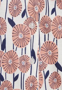 Floral fabric featuring peach-colored flowers with dark navy lines and green leaves, arranged against a white background. Buttons included.