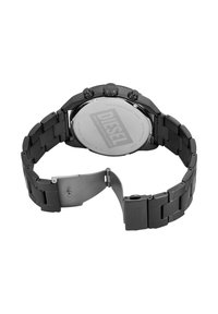 Montre en acier inoxydable noir avec bracelet à maillons, boîtier rond, boutons chronographe et dos réfléchissant affichant le nom de la marque Diesel.
