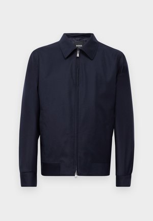 Navy blue zip-up jacket with a collar, long sleeves, and two front pockets, displayed against a plain white background.