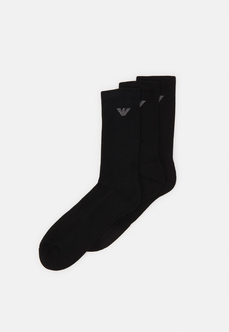 Chaussettes en coton noir avec une texture côtelée, trois paires présentées, avec un petit logo gris sur le dessus pour le branding.