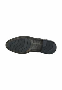 Suola di scarpa in gomma nera con un motivo texturizzato e scanalature per la trazione, caratterizzata da una leggera curvatura e segni di usura visibili.