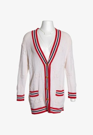 Cardigan bianco lavorato a maglia con bordino a righe rosse, blu navy e bianche, bottoni dorati, due tasche frontali e motivo testurizzato delicato.
