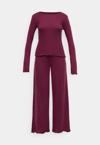 Μαρόν σετ loungewear που περιλαμβάνει ένα πάνω με μακριά μανίκια και στρογγυλή λαιμόκοψη, καθώς και αντίστοιχο παντελόνι σε φαρδιά γραμμή, και τα δύο με κυματιστές άκρες και ραμμένη υφή.