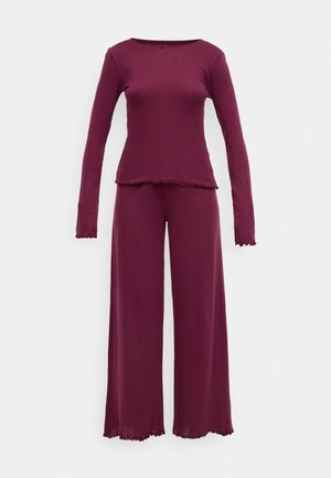 Maroon loungewear set featuring a long-sleeve top with a round neck and matching wide-leg pants, both with scalloped edges and ribbed texture.