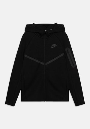 Black zip-up hoodie with a lined hood, raglan sleeves, and a side zip pocket. Features a subtle Nike logo on the chest and diagonal accents.