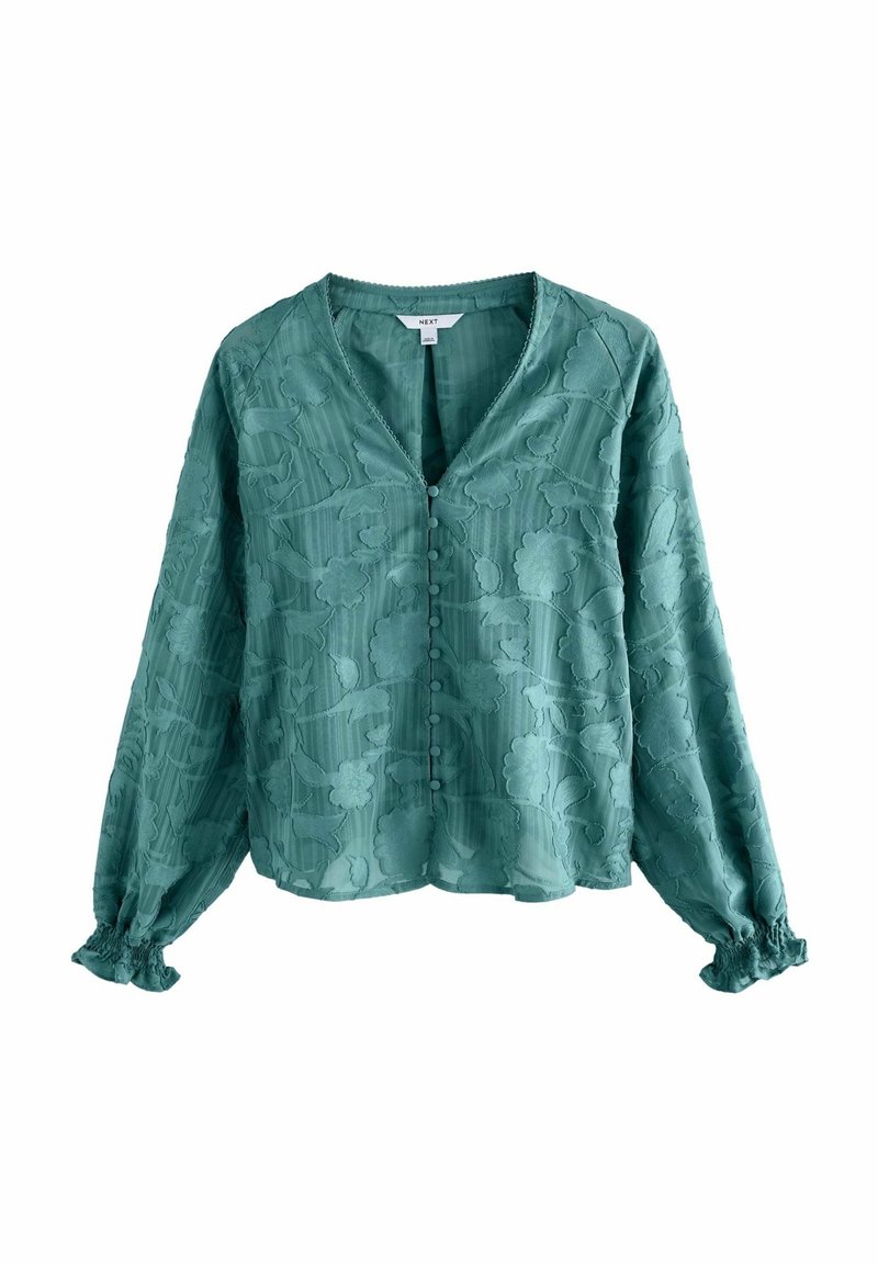 Blusa a maniche lunghe color turchese con un motivo floreale testurizzato, scollatura a V, chiusura con bottoni e polsini arricciati. Tessuto morbido e leggero.