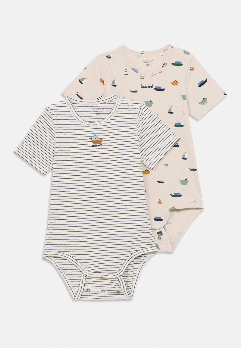 Δύο κορμάκια με κοντό μανίκι: ένα με οριζόντιες ρίγες και γραφικό πλοίο, το άλλο μπεζ με πολύχρωμα μοτίβα πλοίων και κουμπιά ασφαλείας.