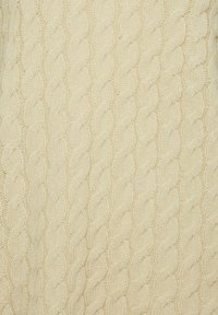 Knit sweater in cream, featuring a textured cable pattern, with a soft, wool-like material and a cozy, thick construction.