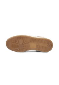 Sneaker outsole with a textured rubber design, circular and linear patterns, predominantly beige with a light brown accent near the heel.