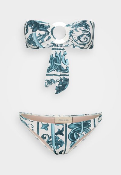 Two-piece bikini set featuring a bandeau top with a circular accent and a tie. The fabric displays a blue floral pattern on a white base.