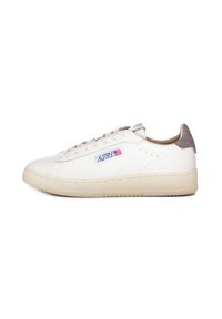 Sneaker in pelle bianca con suola in gomma beige, punta rotonda, cuciture sottili e accentuazione in suede grigia sul tallone. Logo laterale in blu e rosso.
