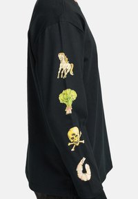 Black long-sleeve shirt with embroidered left sleeve designs: a horse, broccoli, skull, and shrimp, showcasing vibrant colors and playful patterns.