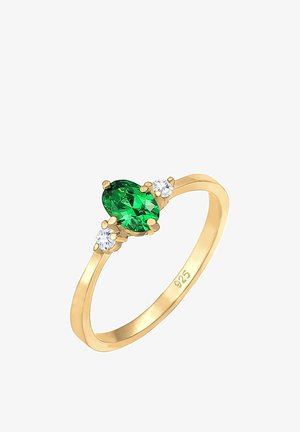 Bague en or avec une pierre précieuse ovale verte centrale entourée de deux petites pierres rondes transparentes sur un anneau fin marqué 925.