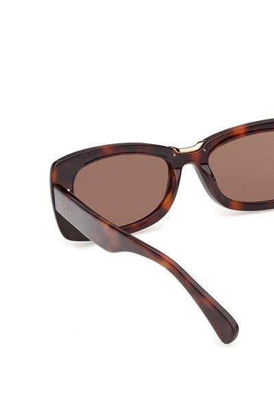 Tortoise shell-patterned sunglasses with brown tinted lenses, featuring thick frames and a slight cat-eye shape.