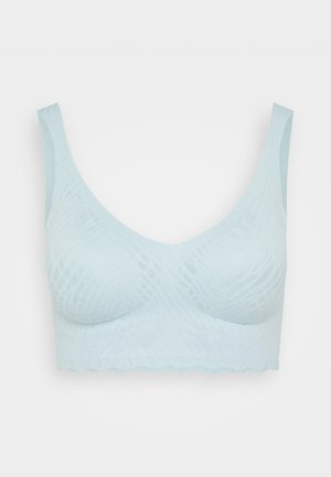 Light blue soft-textured bra with a seamless design, wide straps, and subtle geometric pattern. Scalloped edges at the bottom.