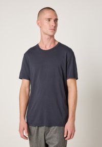 Navy blue cotton t-shirt featuring a classic crew neckline and short sleeves, with a smooth texture and no visible patterns or accents.