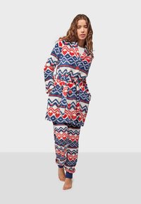 Colorful fleece robe and matching pants featuring a geometric pattern in red, blue, and white. Includes a tie belt and buttons.