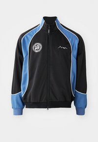 Black and blue athletic jacket, zippered front, contrasting white piping, logo patch on chest, ribbed cuffs, smooth synthetic fabric.