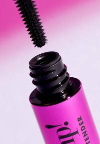 Tubetto di mascara nero con una finitura rosa lucida. L'applicatore ha un pennello con brevi punte simili a setole. Il cappuccio è nero con scanalature per una migliore presa.