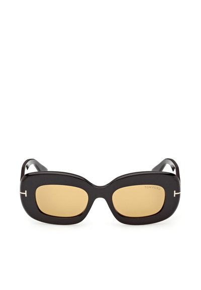 Schwarze, rechteckige Sonnenbrille mit dicken Rahmen und bernsteinfarben getönten Gläsern, versehen mit kleinen silbernen „T“-Logos an den Bügeln.