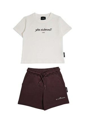 Maglietta bianca a maniche corte con scritta "john richmond" e pantaloncini marrone scuro con coulisse con scritta "RICHMOND" sulla gamba sinistra.