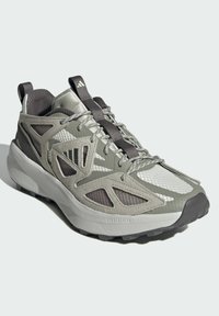 Lightweight athletic shoe in gray tones, featuring mesh and suede materials, a textured outsole, and a lace-up design with reflective accents.
