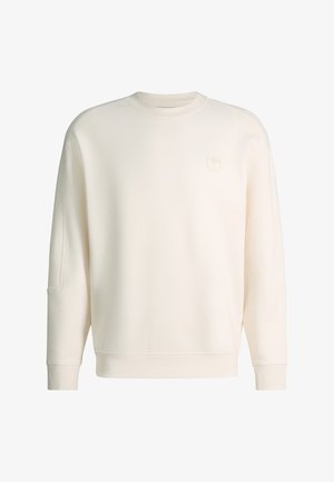 Gebroken witte crewneck-trui met lange mouwen en een klein rond, verhoogd logo op de linkerborst