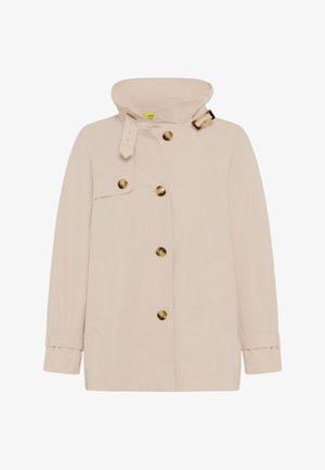 Beige mid-length jacket with high collar, tortoiseshell buttons down front and on chest flap, and buckle strap at collar.