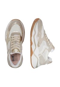 Light tan and white sneakers with mesh and suede materials, featuring a textured sole and lace-up design with metallic accents.