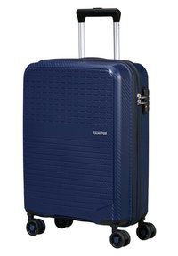 Valigia rigida blu navy con superficie testurizzata, due ruote lisce, manico estraibile e chiusura a doppia zip.