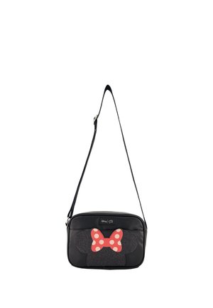 Sac bandoulière noir avec oreilles de Minnie Mouse et nœud rouge à pois blancs sur le devant, bandoulière réglable et étiquette Disney.