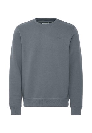 Plain blue-gray long-sleeve crewneck sweatshirt with ribbed cuffs and hem, and subtle "blend" logo on the left chest.