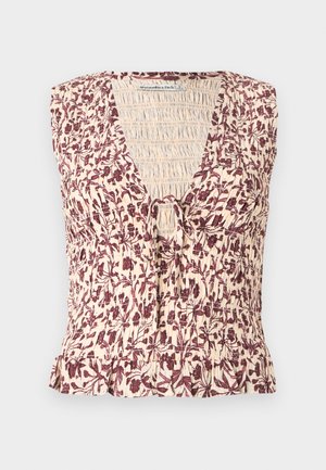 Vzorované halenka bez rukávů s květinovým potiskem, výstřihem do V, nařasená detail a zavazování vpředu; má krémovou základnu a burgundské akcenty.