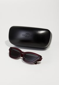 COACH Aurinkolasit - transparent deep red