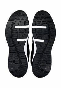 Scarpe sportive Nike con suola in gomma nera, motivo di presa texturizzato e accenti bianchi. Il design include scanalature per la flessibilità.