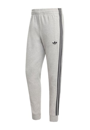 Sive pamučne trenirke sa suženim krojem, s crnim bočnim prugama i malim crnim logotipom na bedru. Elastični pojas za udobnost.