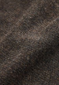Brown patterned fabric with a textured weave, showcasing various shades of brown and slight fuzziness, creating a dense, rich appearance.